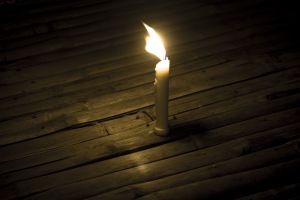A single candle, glowing brightly