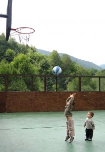 A little boy shoots a basketball