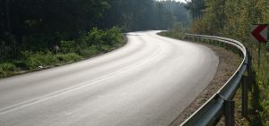A picture of a winding mountain road with guard rails